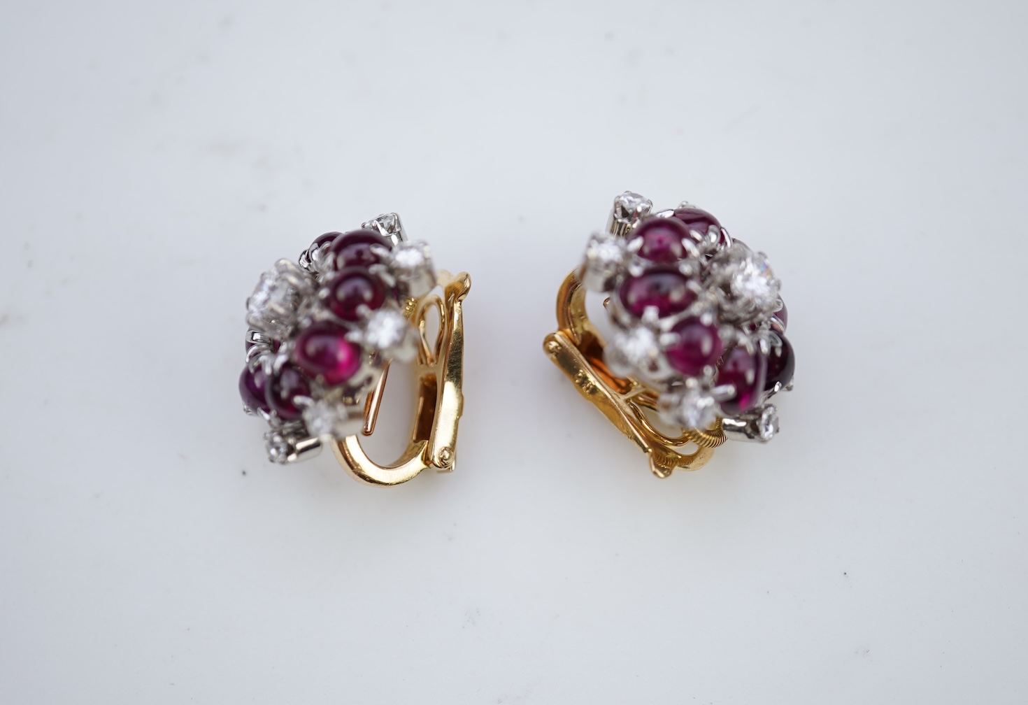 A pair of ruby and diamond ear clips, mid 20th century